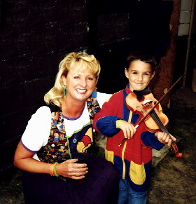 Cindy Cook visits with a young violinist after a show